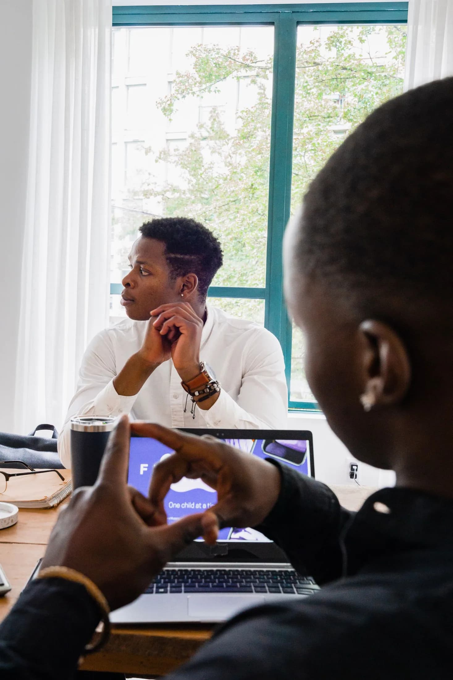 Two people in a business planning conversation; thematic stock photography